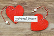 Friends forever card with two red wooden hearts