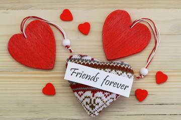 Wall Mural - friends forever card with wooden and knitted hearts