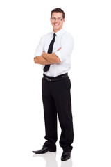 Wall Mural - young businessman standing with arms crossed