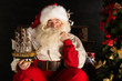© Milles Studio - Santa Claus at home playing with new toys near Christmas Tree