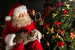 © Milles Studio - Santa Claus making a most wanted gift to a child placing cute ca