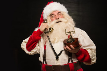 Portrait of happy Santa Claus calling phone