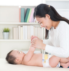 mother playing with baby