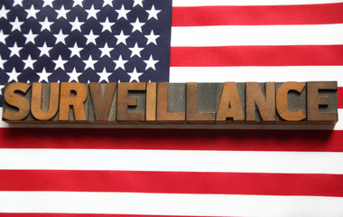 Wall Mural - the word 'surveillance' on an American flag