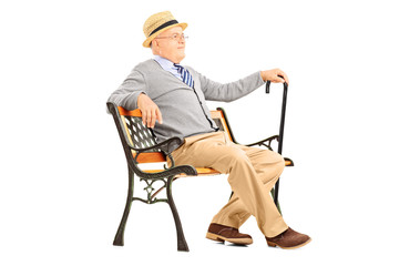 Poster - Relaxed senior man sitting on a wooden bench and thinking