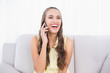 © lightwavemedia - Laughing pretty brunette using mobile phone