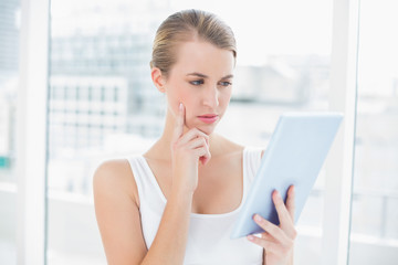 Wall Mural - Focused sporty woman using tablet computer