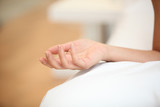 Fototapeta Zwierzęta - Closeup of a woman's hand on a bed