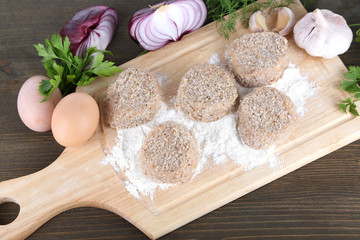 Poster - Meat patties on board on wooden table