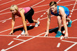 © stockyimages - Athletes at starting line on race track