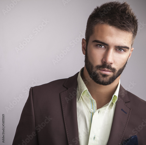 Naklejka dekoracyjna Elegant young handsome man. Studio fashion portrait.