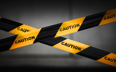 black and yellow striped caution tape barrier
