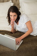 © lightwavemedia - Peaceful pretty brown haired woman using a laptop
