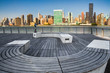 Modern wooden bench at park with view of New York City skyline