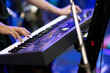 hands of musician playing keyboard in concert