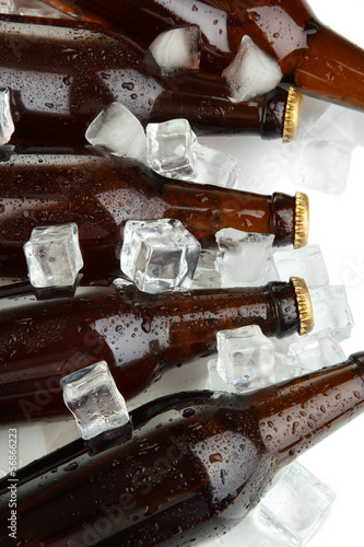 Naklejka na kafelki Beer bottles in ice cubes close up