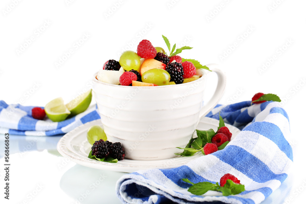 Fruit salad in cup near napkin isolated on white
