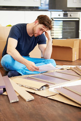 Wall Mural - Frustrated Man Putting Together Self Assembly Furniture