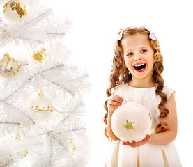 Child decorate white Christmas tree.