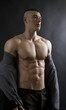 © kalcutta - Young sexy man with athletic body on black background.