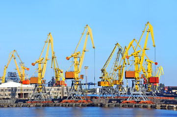 Port cargo crane over blue sky background