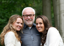 Happy Father Together With Two Smiling Daughters