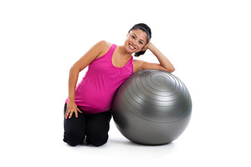 Healthy pregnant Hispantic woman with exercise ball isolated