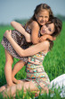 © mr.markin - Happy girls on green grass. Playing