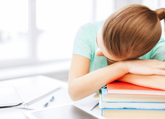 Canvas Print - tired student sleeping on stock of books