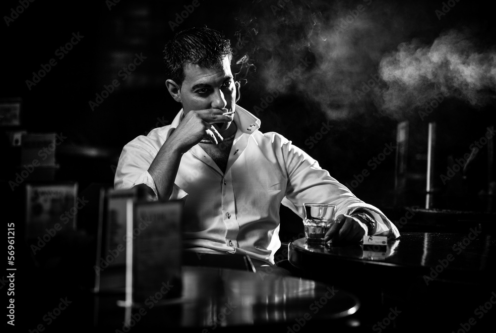 black and white cigarette Black and white portrait of man smoking cigarette in restaurant Stock Photo
