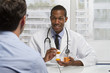 © Burlingham - African American doctor holding prescription, horizontal