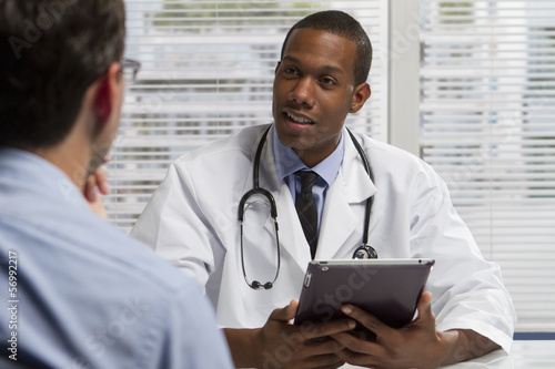 Fotografía African American doctor with tablet and patient, horizontal