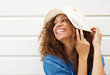 Beautiful young woman laughing and wearing summer hat