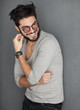 © matusciac - sexy fashion man with beard dressed casual smiling against wall