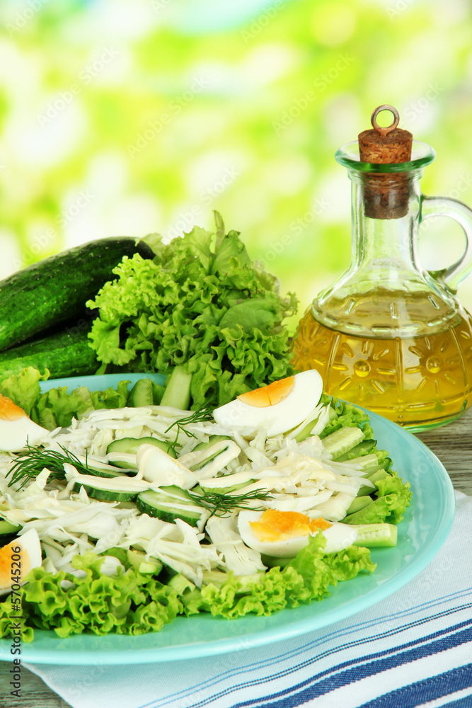 Delicious salad with eggs, cabbage and cucumbers on wooden
