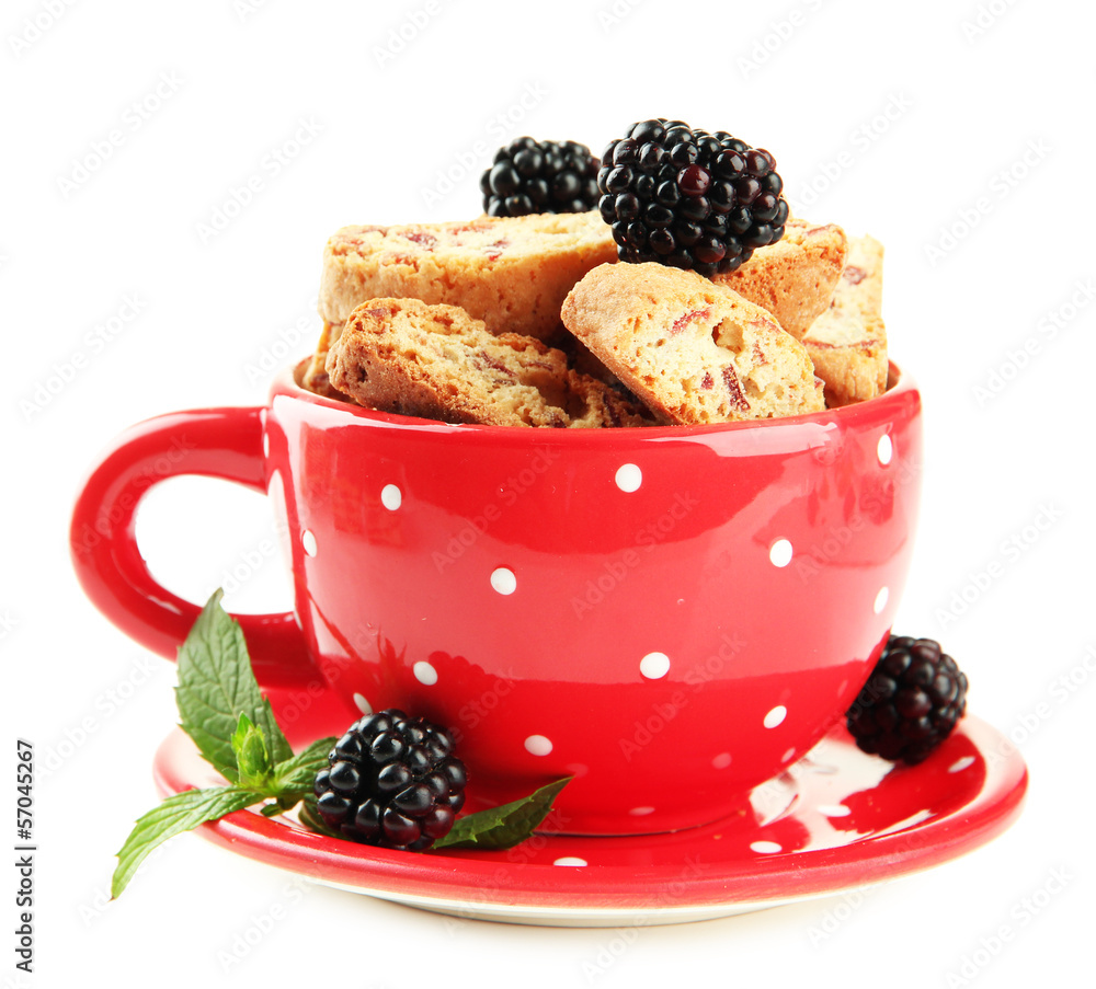 Tasty cookies with blackberry in cup isolated on white