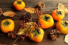 Persimmons,fall Leaves And Pinecones
