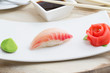 Grouper sushi nigiri on white plate with soy sauce chopsticks