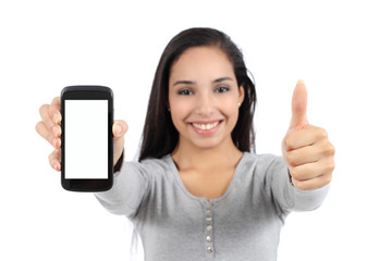 Wall Mural - Woman showing a blank smart phone screen and thumb up isolated