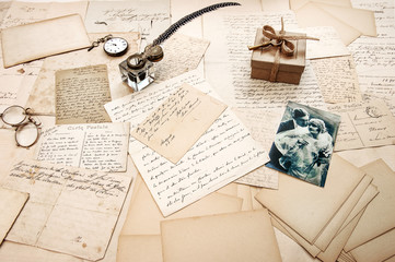 old letters, vintage postcards and retro picture of couple