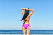 © M-Production - Young woman sunbathes at the beach. From the back.
