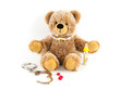 Teddybär mit Süßigkeiten und Handschellen