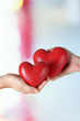© Africa Studio - Hearts in hands on light background