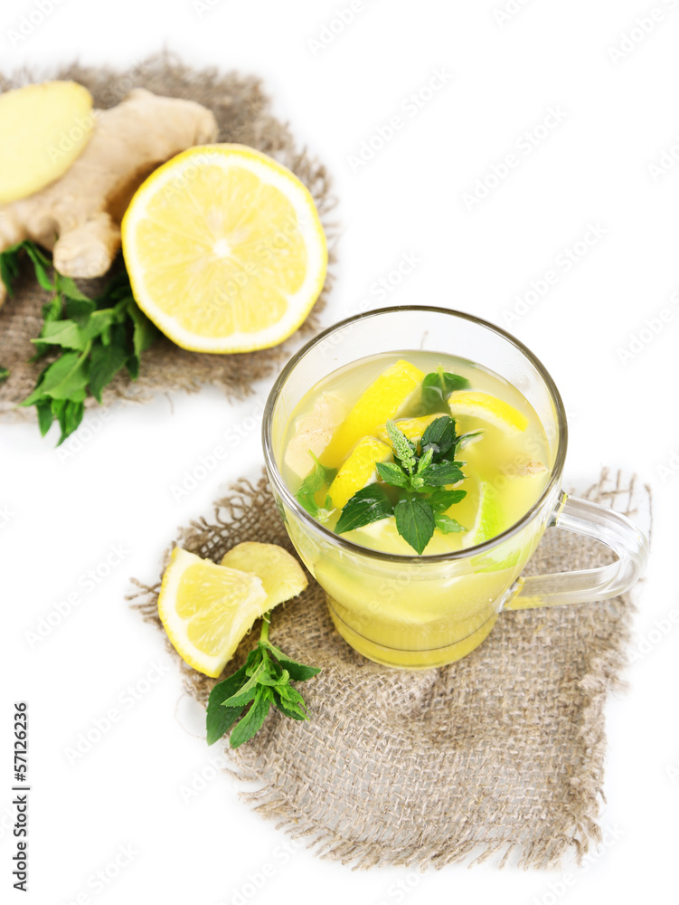 Cup of tea with ginger on sackcloth isolated on white