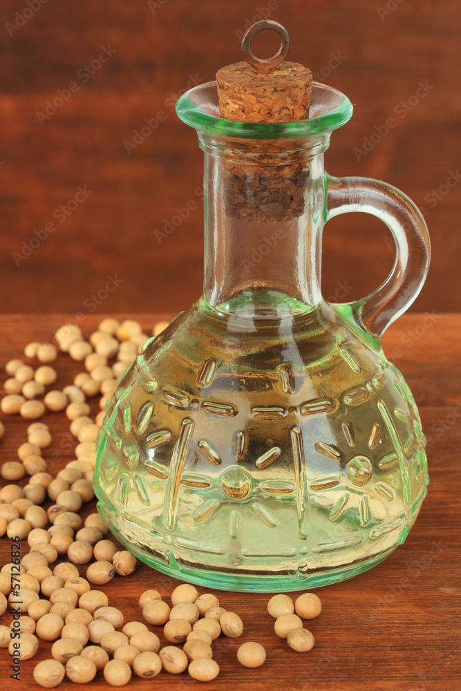 Soy beans and oil on wooden background