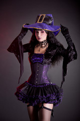 Poster - Smiling witch in purple and black gothic Halloween costume