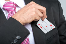Businessman Pulling Out His Pocket Aces Cards