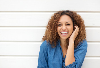 Portrait of a beautiful woman laughing with hand in hair