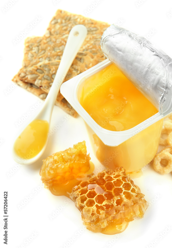 Tasty dessert in open plastic cup and honey combs, isolated