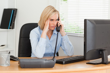 Charming  businesswoman on phone looking at screen while having